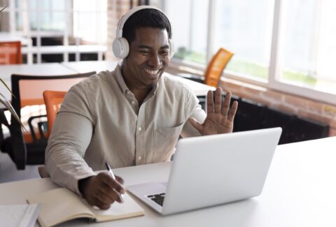 medium-shot-man-waving-laptop