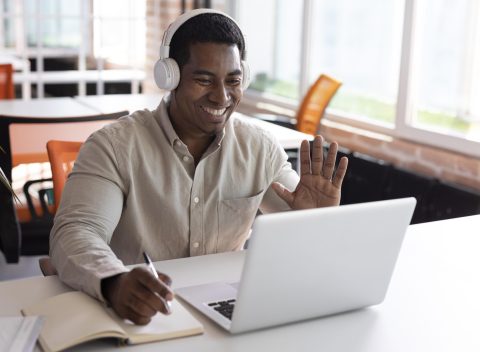 medium-shot-man-waving-laptop