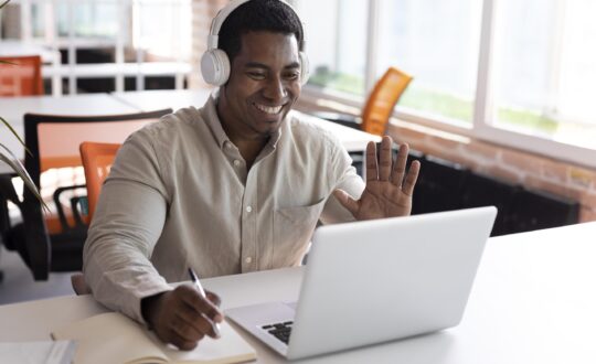 medium-shot-man-waving-laptop