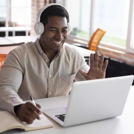 medium-shot-man-waving-laptop