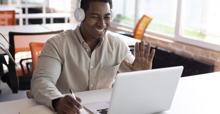 medium-shot-man-waving-laptop